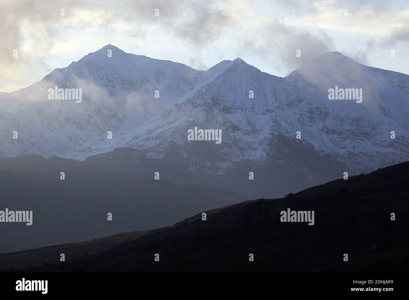 Sunset over the Snowdon horseshoe across showing recent snowfall.  Wales.   Picture taken 5th December 2020 Stock Photo