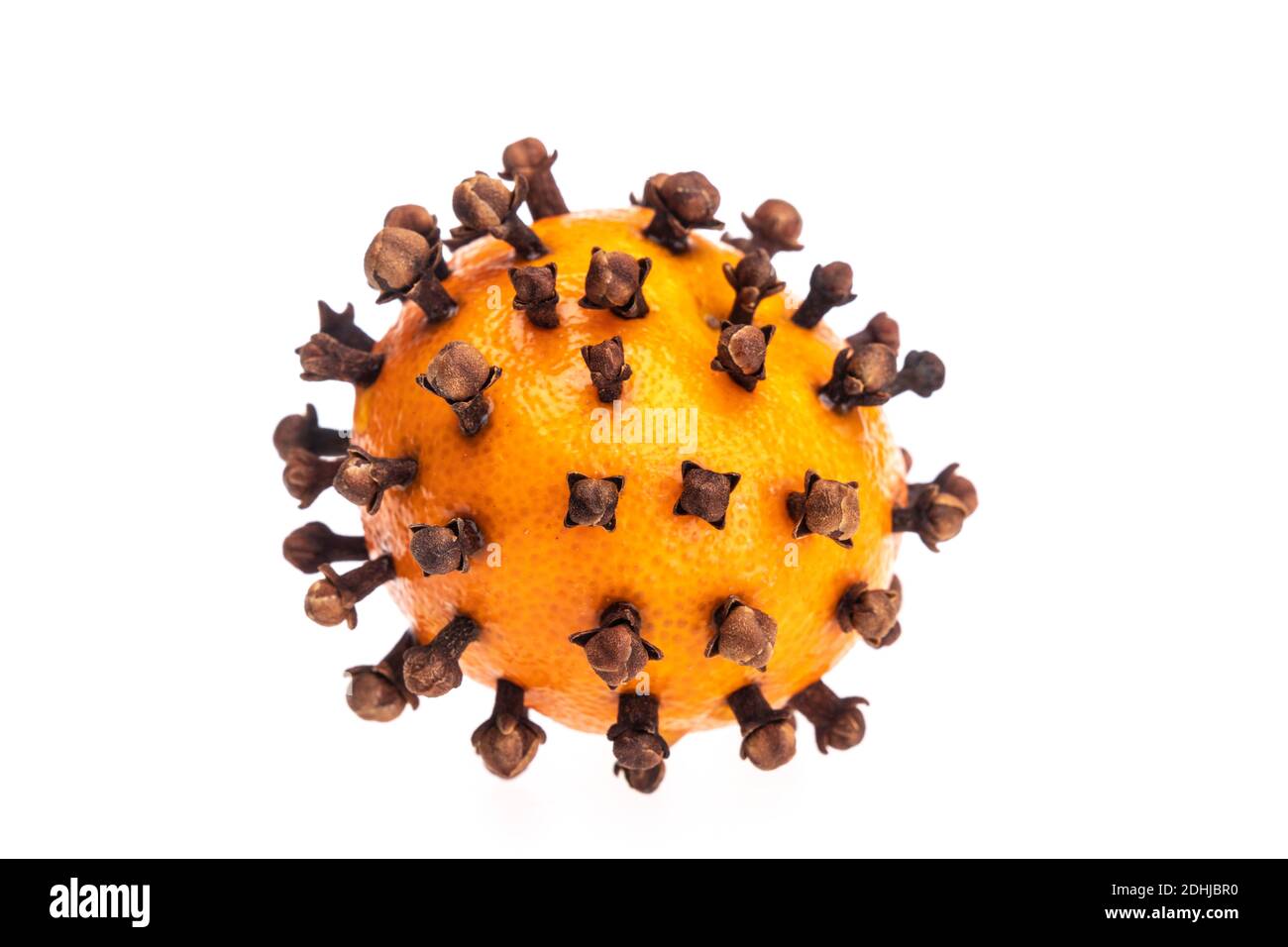 A satsuma srtuck with cloves for Christmas 2020 mulled wine - or as a tree ornament likely to go soggy very quickly. Clovid-19... Stock Photo
