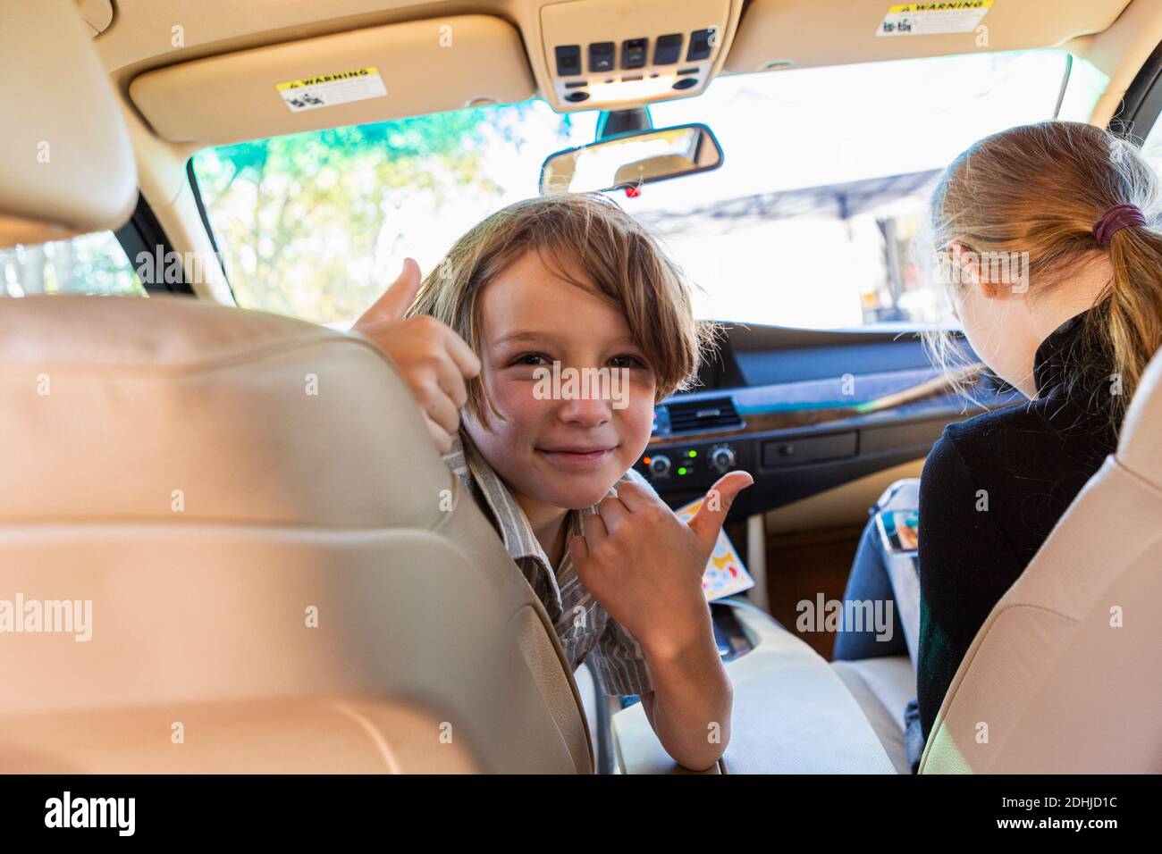 Young boy looking at camera in parked car Stock Photo - Alamy