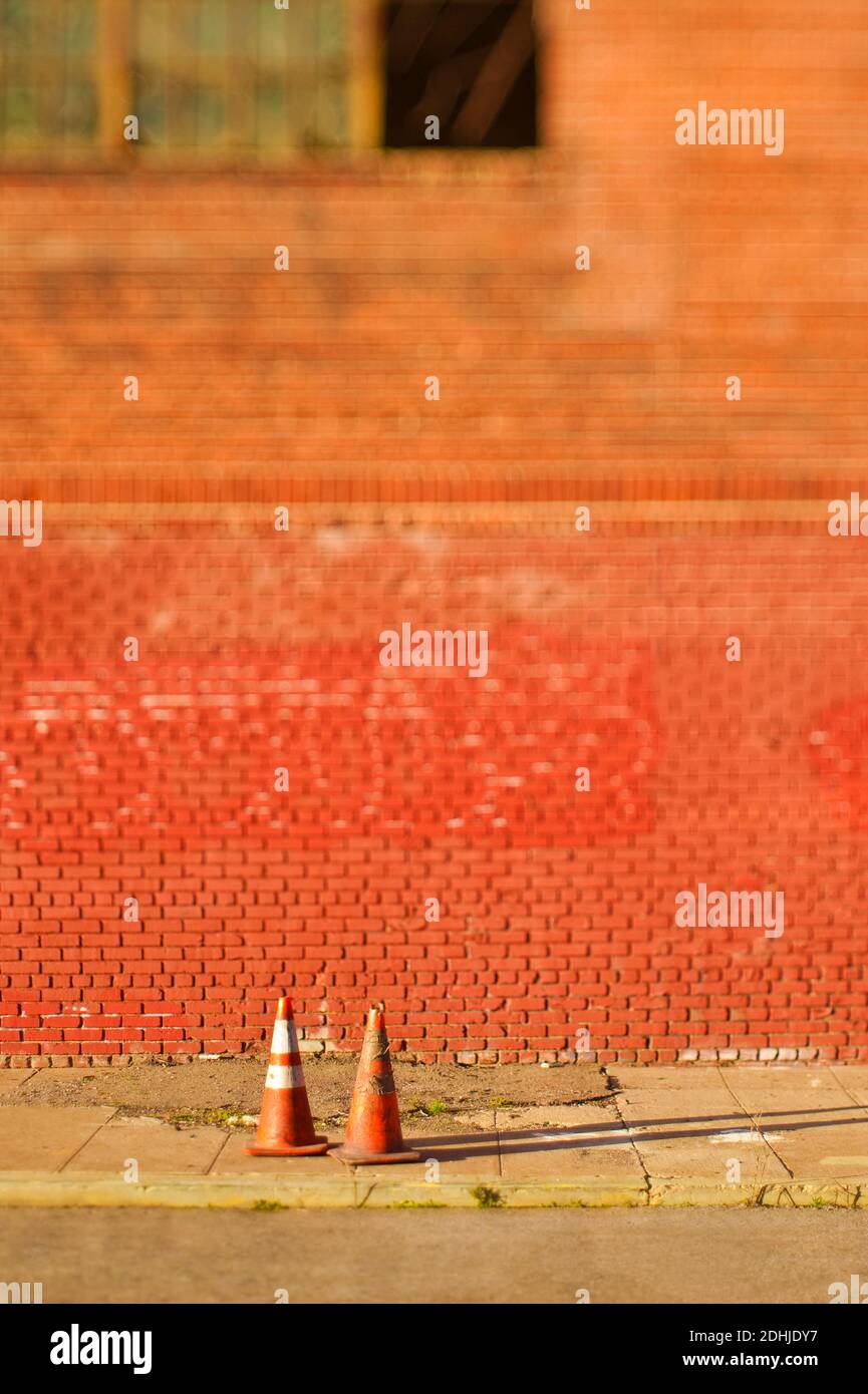 Traffic cones on sidewalk outside brick building Stock Photo Alamy