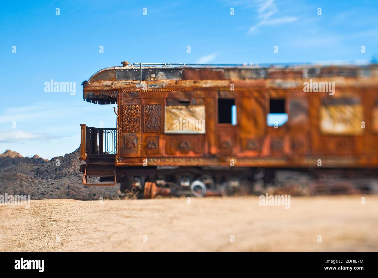 Rusty vintage train carriage in desert. Stock Photo