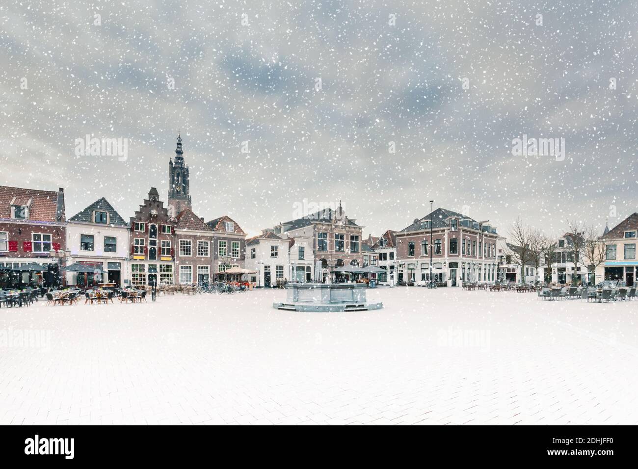 Winter view of the central square with ancient buildings during snowfall in the Dutch city of Amersfoort, The Netherlands Stock Photo