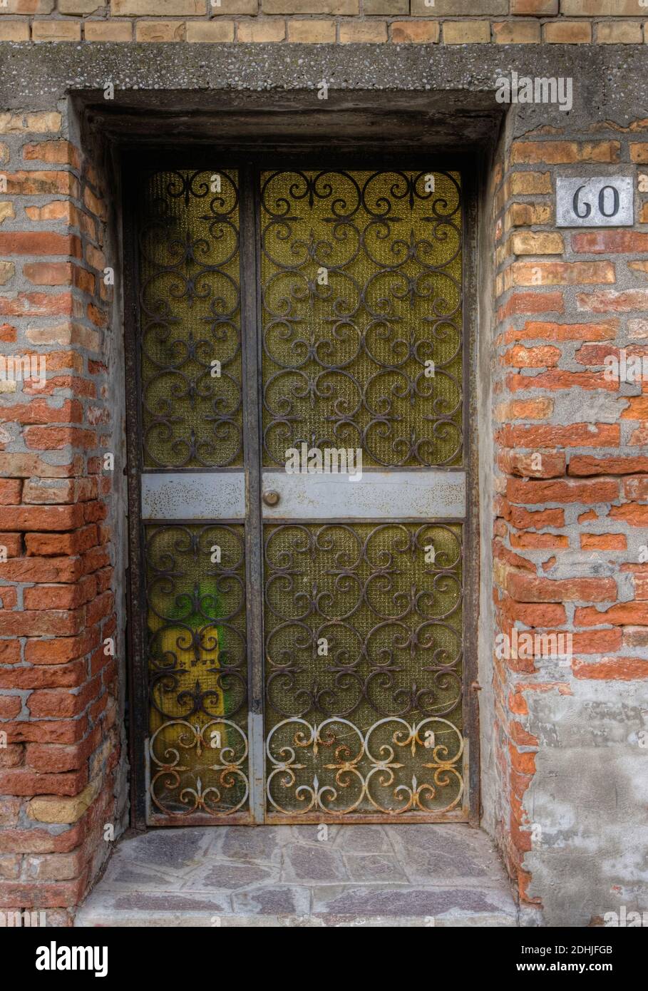 Metal gate in brick wall Stock Photo Alamy