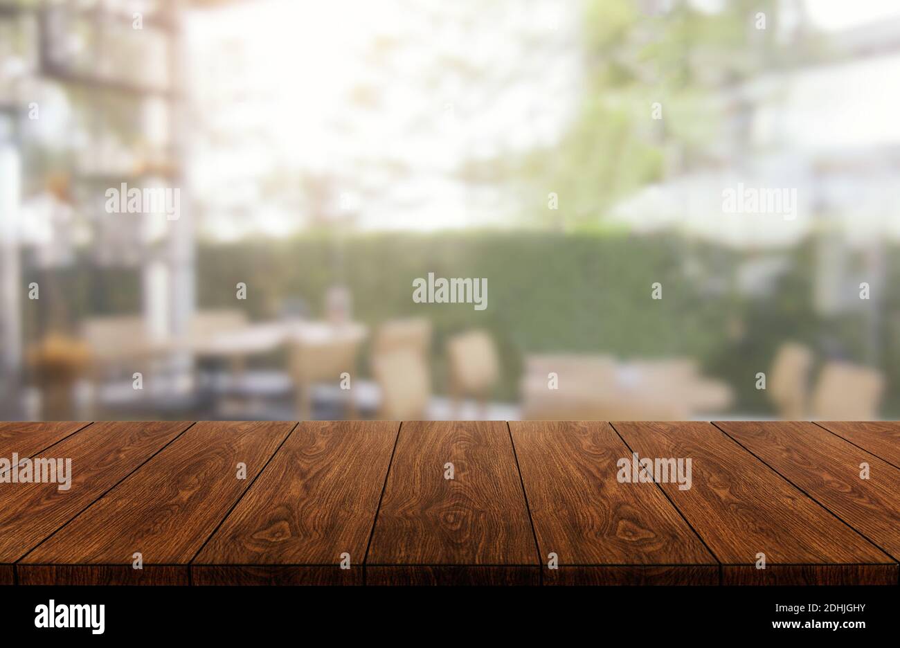 Wood table in blurry background of modern restaurant room or coffee shop with empty copy space on the table for product display mockup. Interior Stock Photo