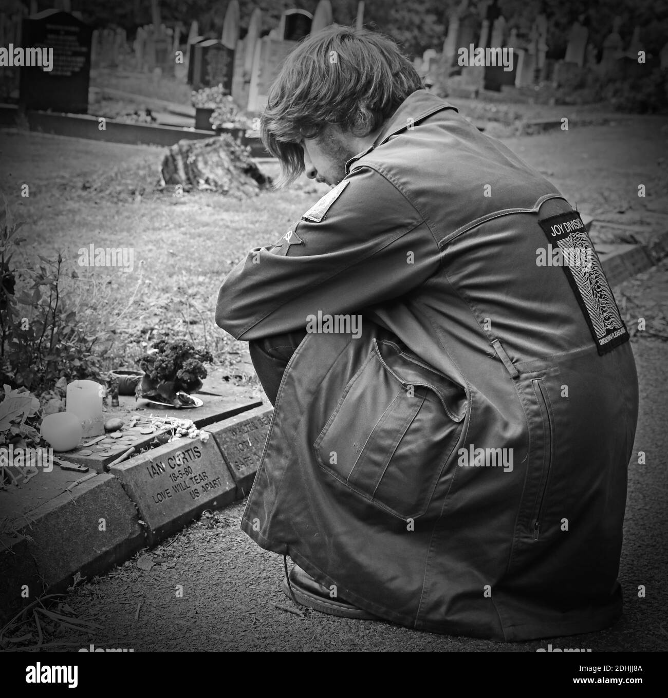 Fan at Ian Curtis memorial stone at  Macclesfield Crematorium,Prestbury Road,Cheshire,England,UK,SK10,Factory label,Joy Division vocalist,song writer Stock Photo