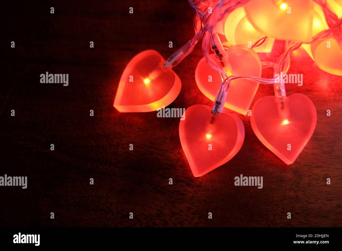 illuminated red heart lights on dark background Stock Photo