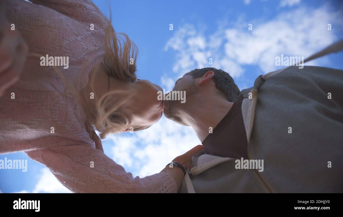 Amorous couple kissing on a background of blue sky Stock Photo - Alamy