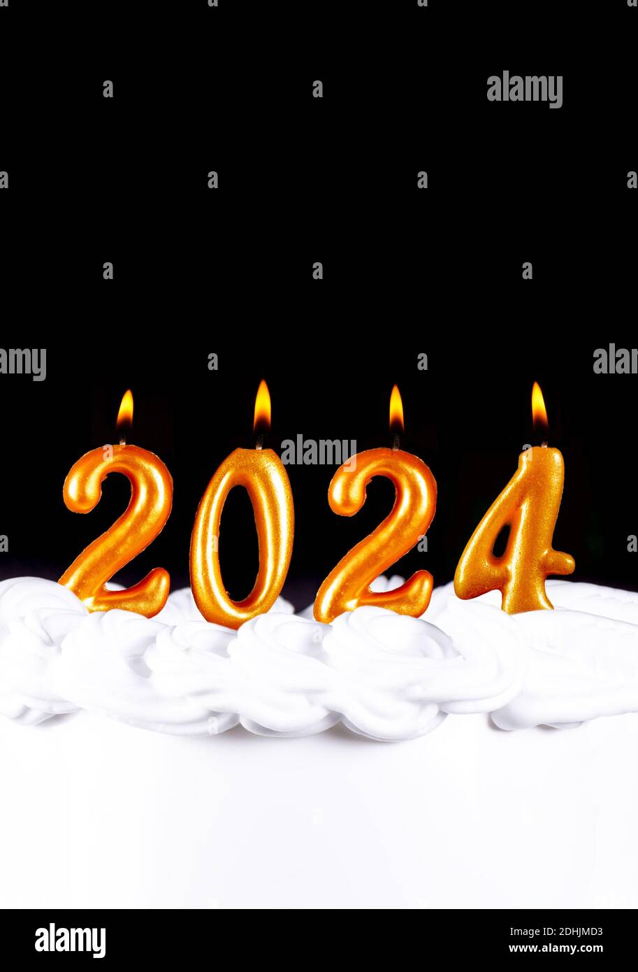 Four golden candles write numbers flame happy new year 2024 black background Stock Photo