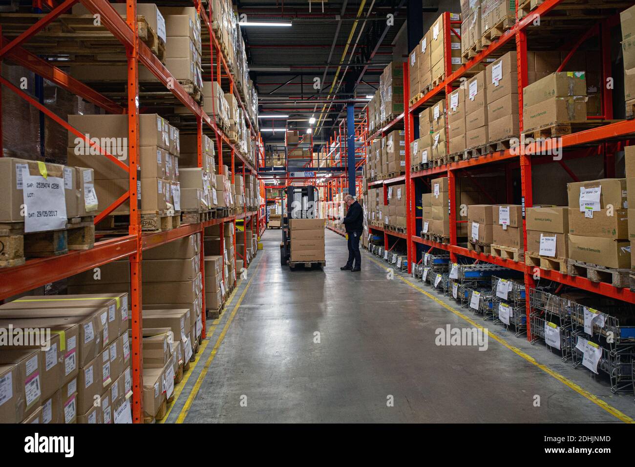 Warehouse worker with a forklift in warehouse Stock Photo