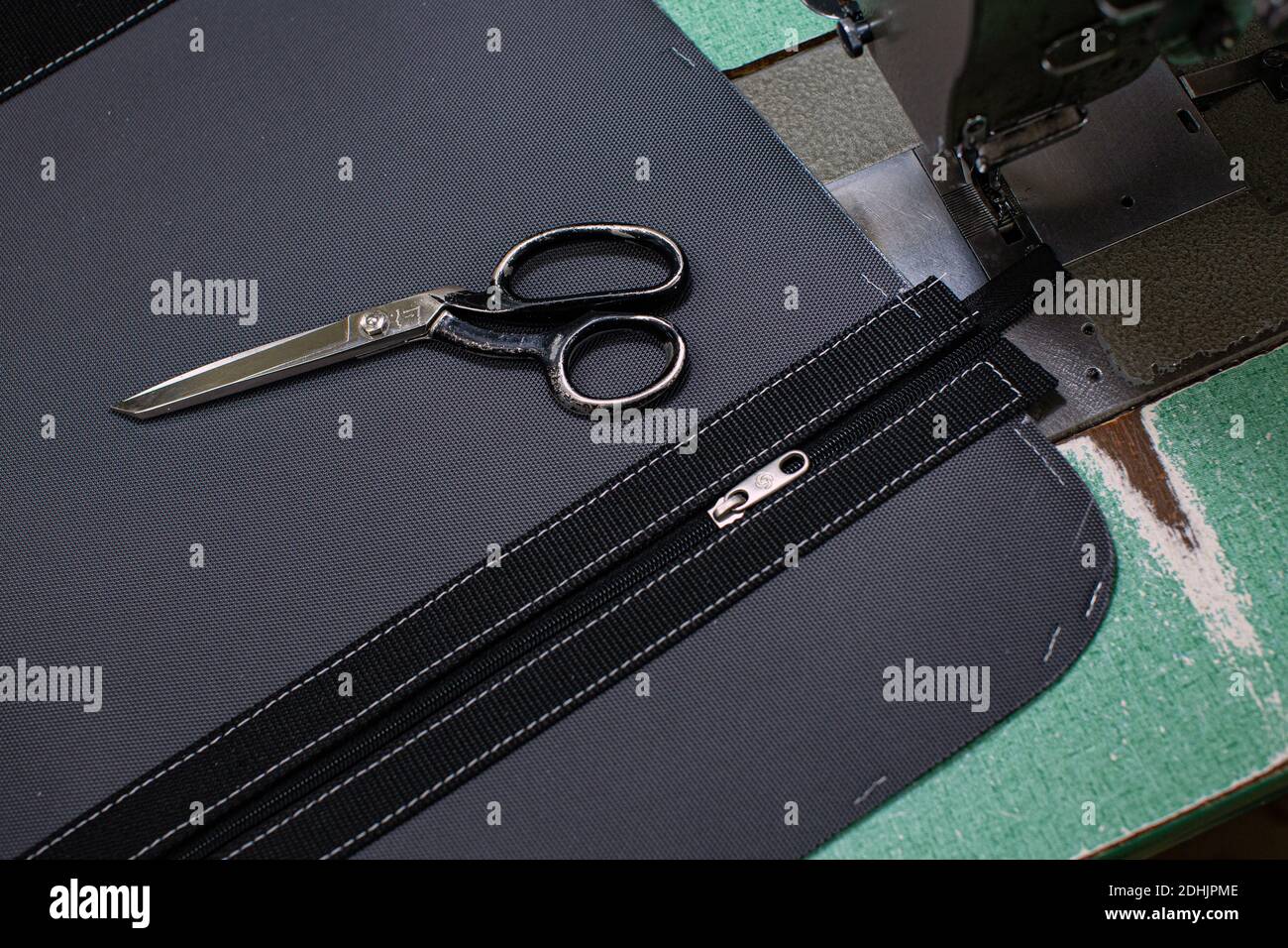 suitcase zipper and scissor in repair workshop Stock Photo