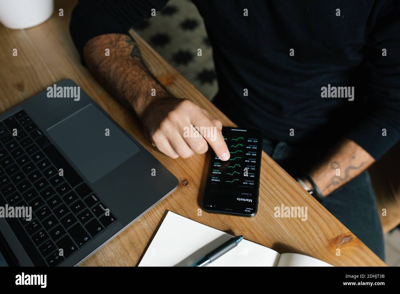 High angle of crop anonymous male entrepreneur using mobile app and ...