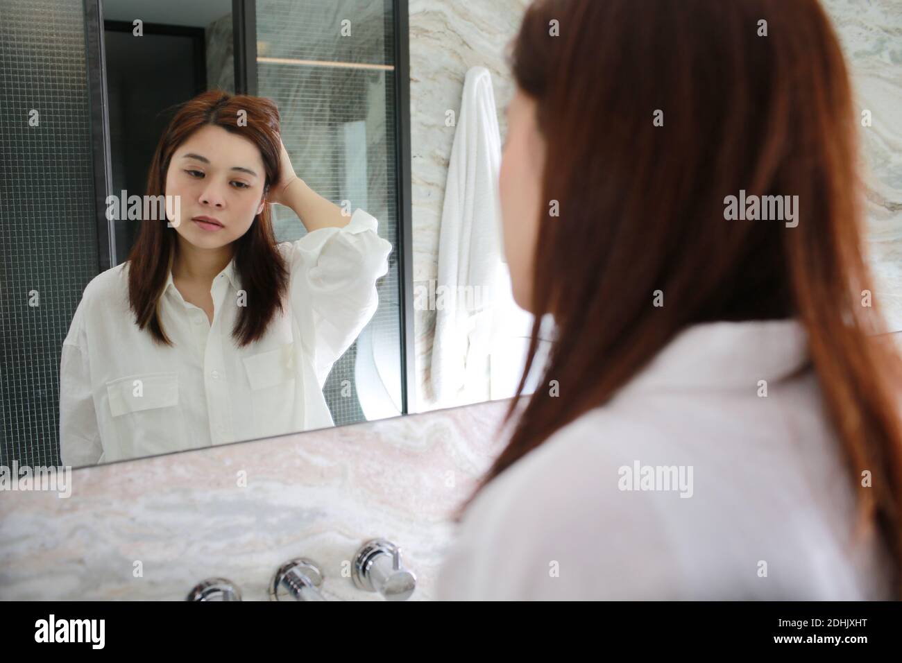 woman yawn to the mirror after wake up and go to bathroom Stock Photo