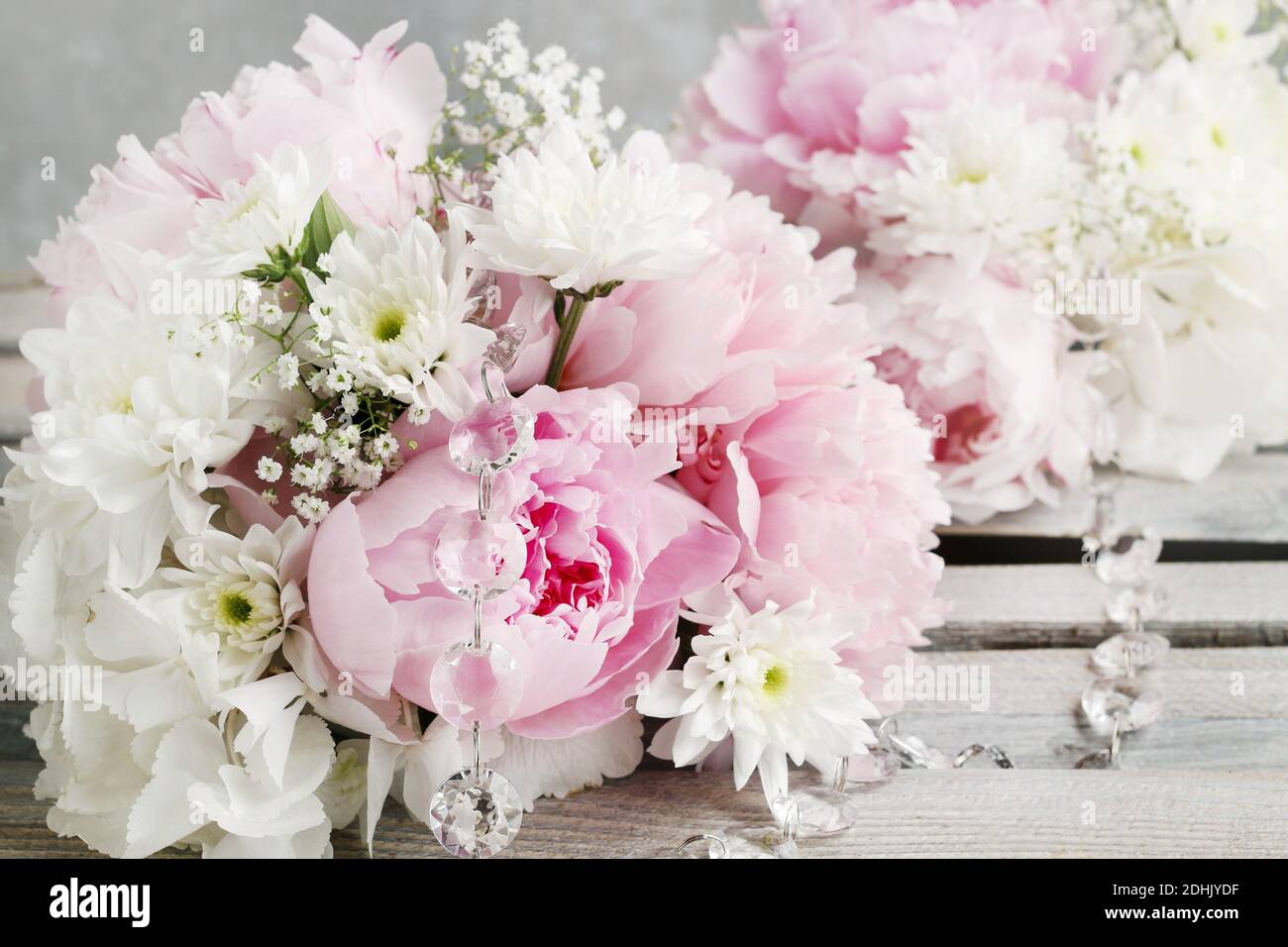 Floral arrangement with pink peonies, white chrysanthemums and gypsophila paniculata twigs