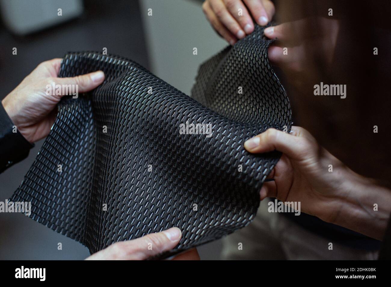 Close up of hands checking quality of material  at the Samsonite production site in Oudenaarde, Belgium Stock Photo