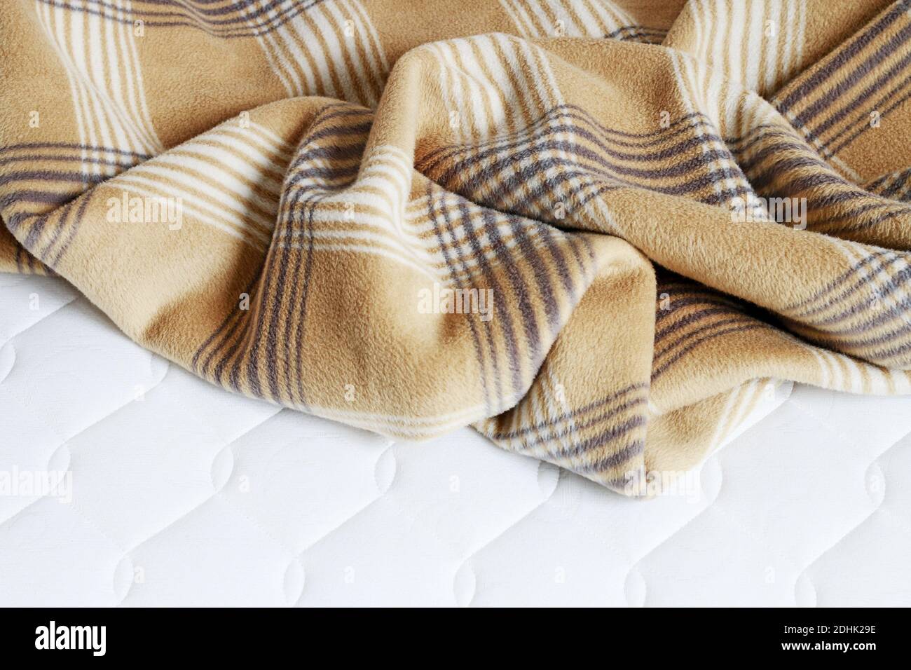 Beige blanket on the new mattress. Graphic resources Stock Photo