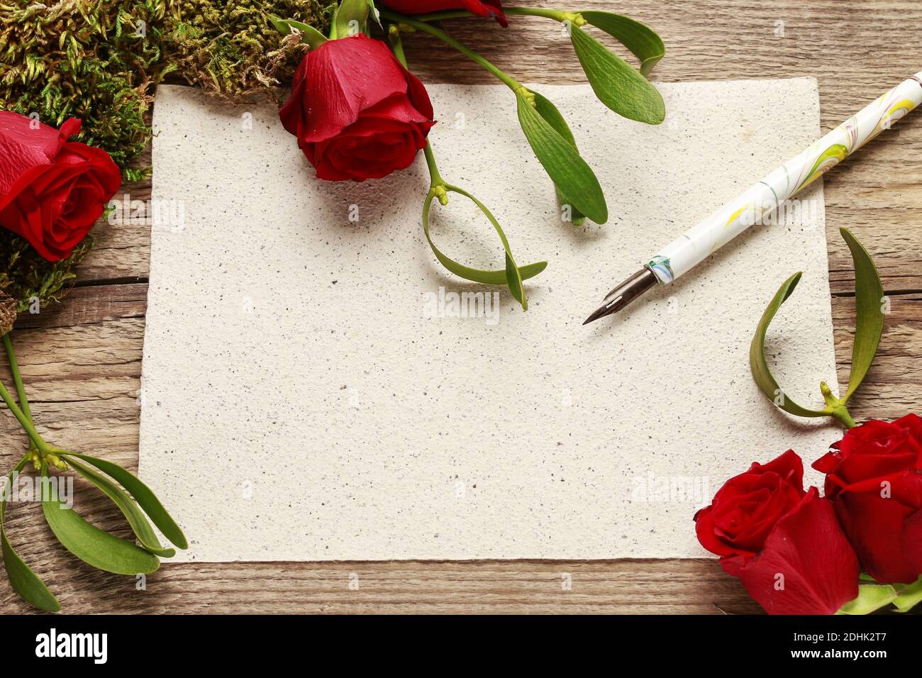 Red roses, mistletoe, moss and blank sheet of paper. Graphic resources Stock Photo