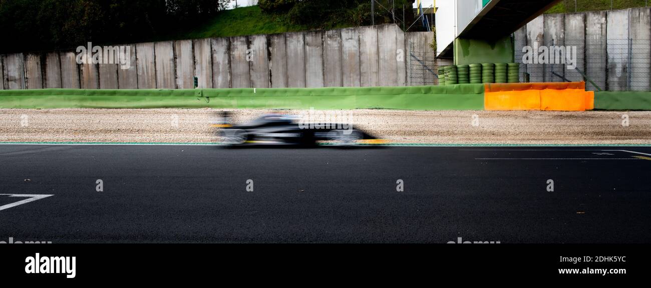 Speed concept blurred motion racing car on asphalt track side view Stock Photo
