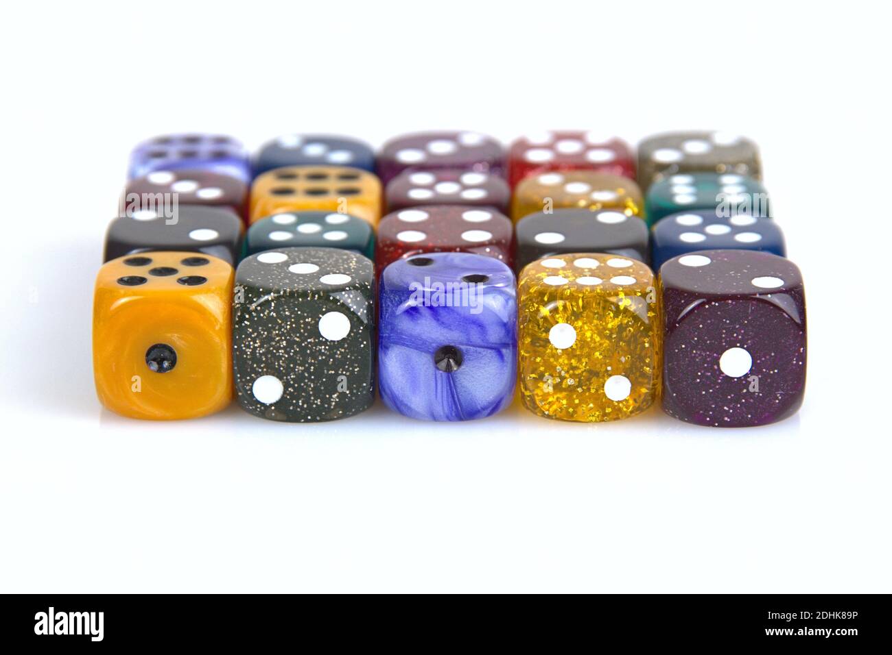 Deutschland. 08th Dec, 2020. The die is cast'. Colorful dice in a row with a slight reflection on the ground in front of a neutral background. | usage worldwide Credit: dpa/Alamy Live News Stock Photo