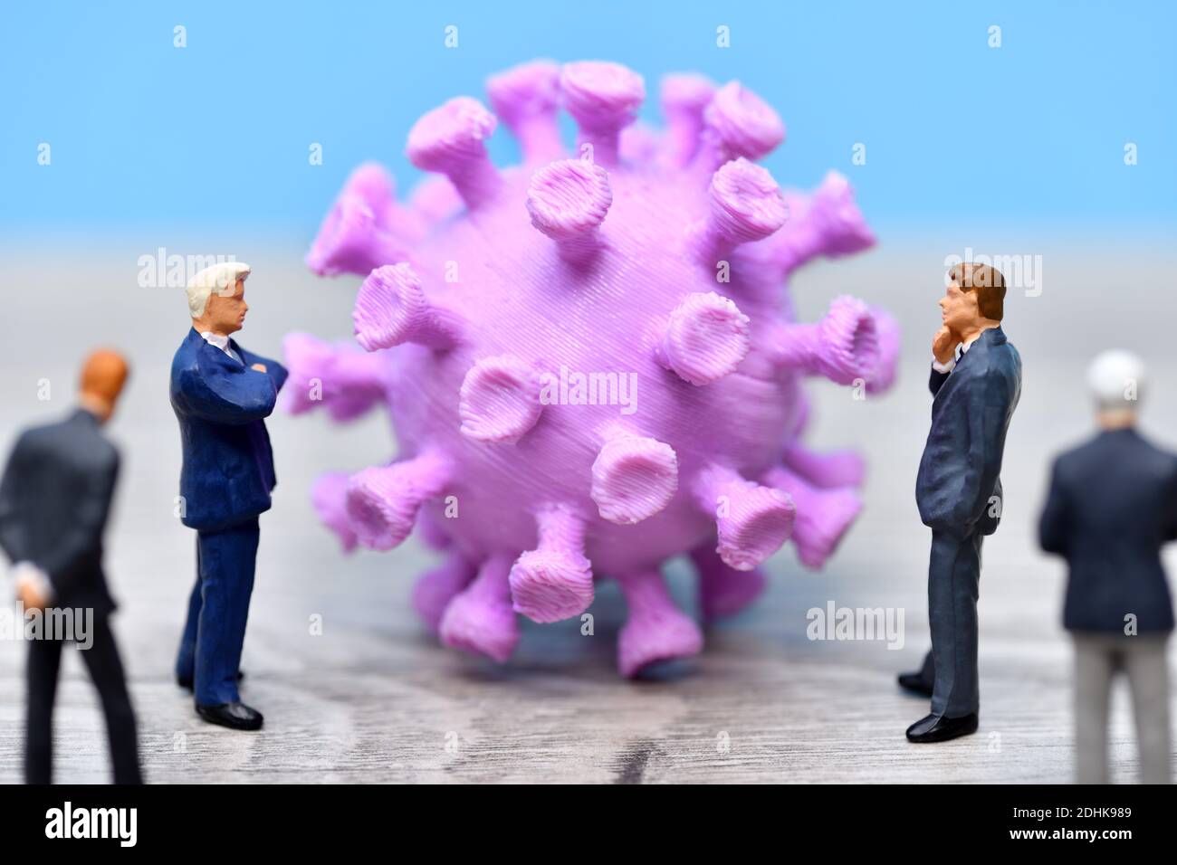 Businessmen Figures Standing Around Coronavirus Stock Photo
