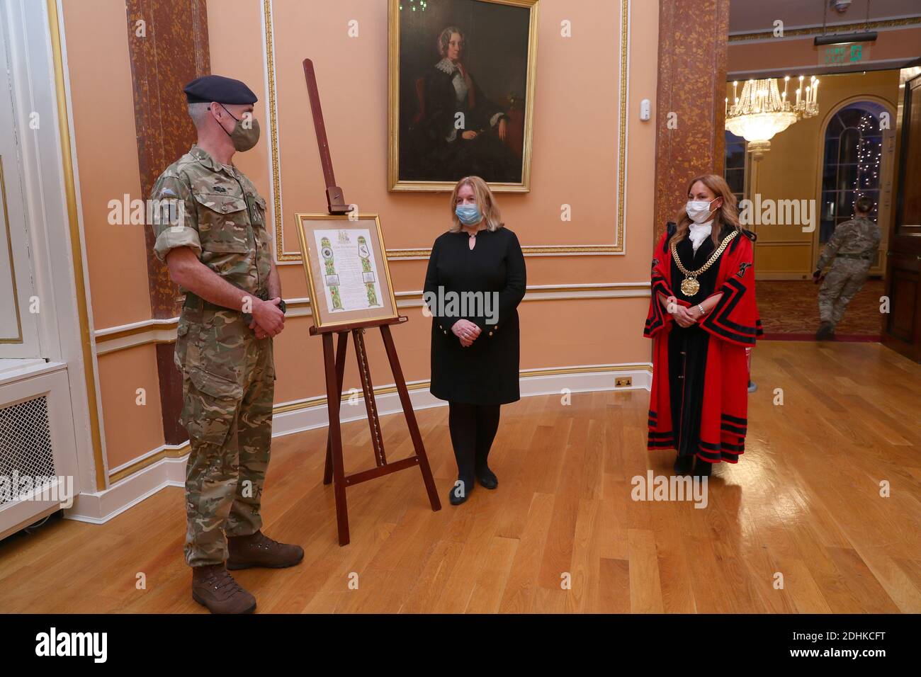 Lord Mayor of Liverpool, Anna Rothery and Deputy Mayor of Liverpool, Councillor Wendy Simon presents a scroll to Brigadier Joe Fossey, Commander of the 8th Engineer Brigade, in a ceremony at Liverpool Town Hall. The scroll proposes the inclusion in the Freedom Roll of Associations for the British Army regiments that supported the Covid testing pilot in Liverpool. The decision will be ratified at a council meeting in January and special commemorative coins will be issued to each of the troops involved in the operation as a civic gift from the city. Stock Photo