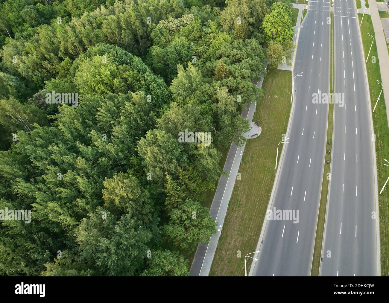 Empty highway road with green park above drone top view Stock Photo