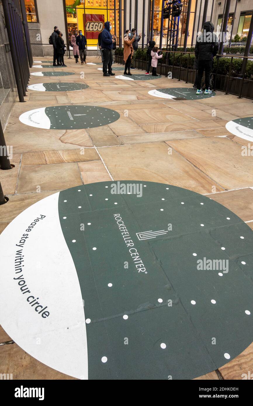 Social Distancing Markers on the sidewalk outside the Christmas Tree at Rockefeller Center, New York City, USA Stock Photo