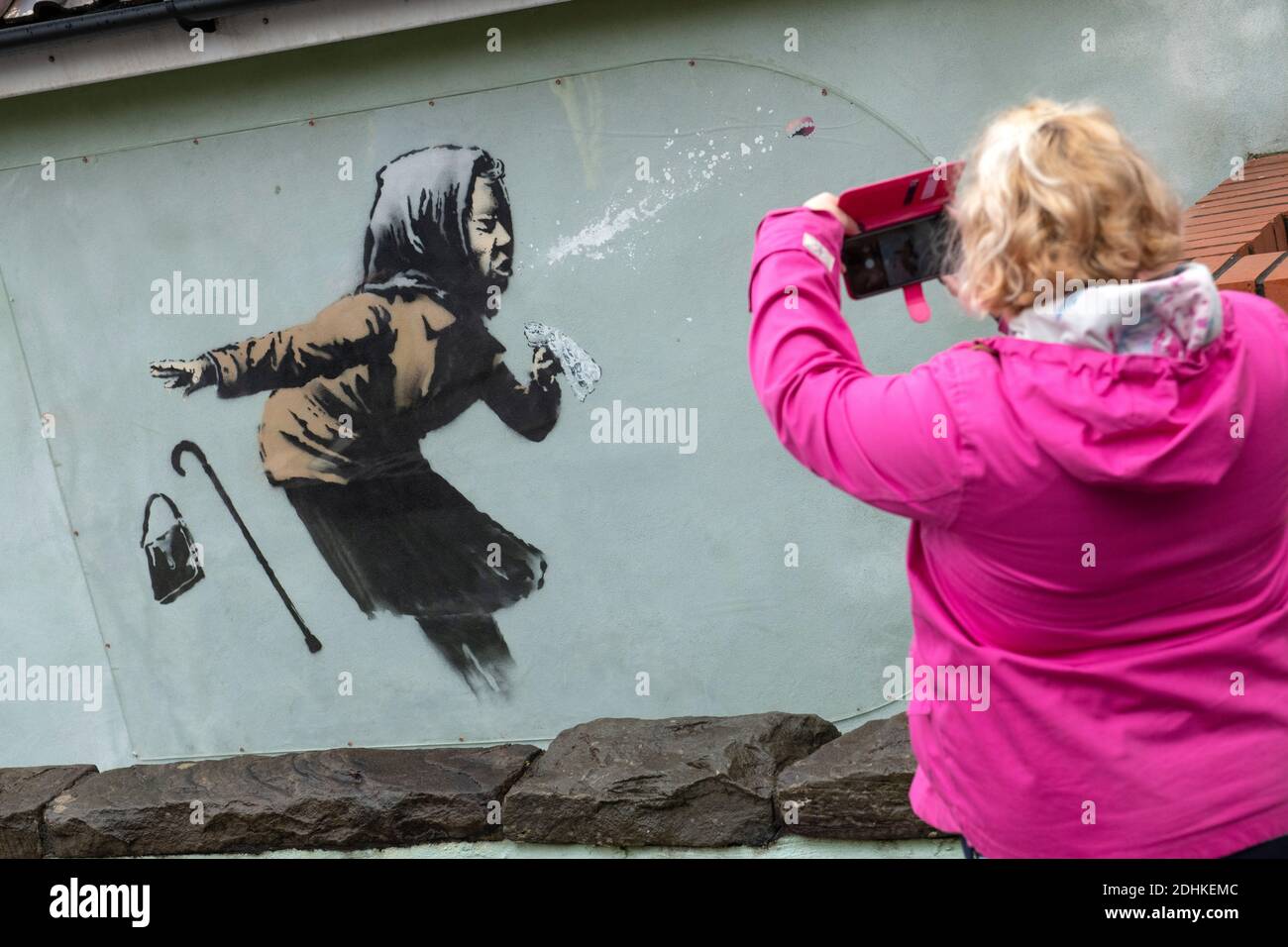 New Banksy art work called 'Aachoo!!' of a sneezing elderly woman loosing her false teeth on a house in Vale Street. Totterdown, Bristol, UK. Stock Photo