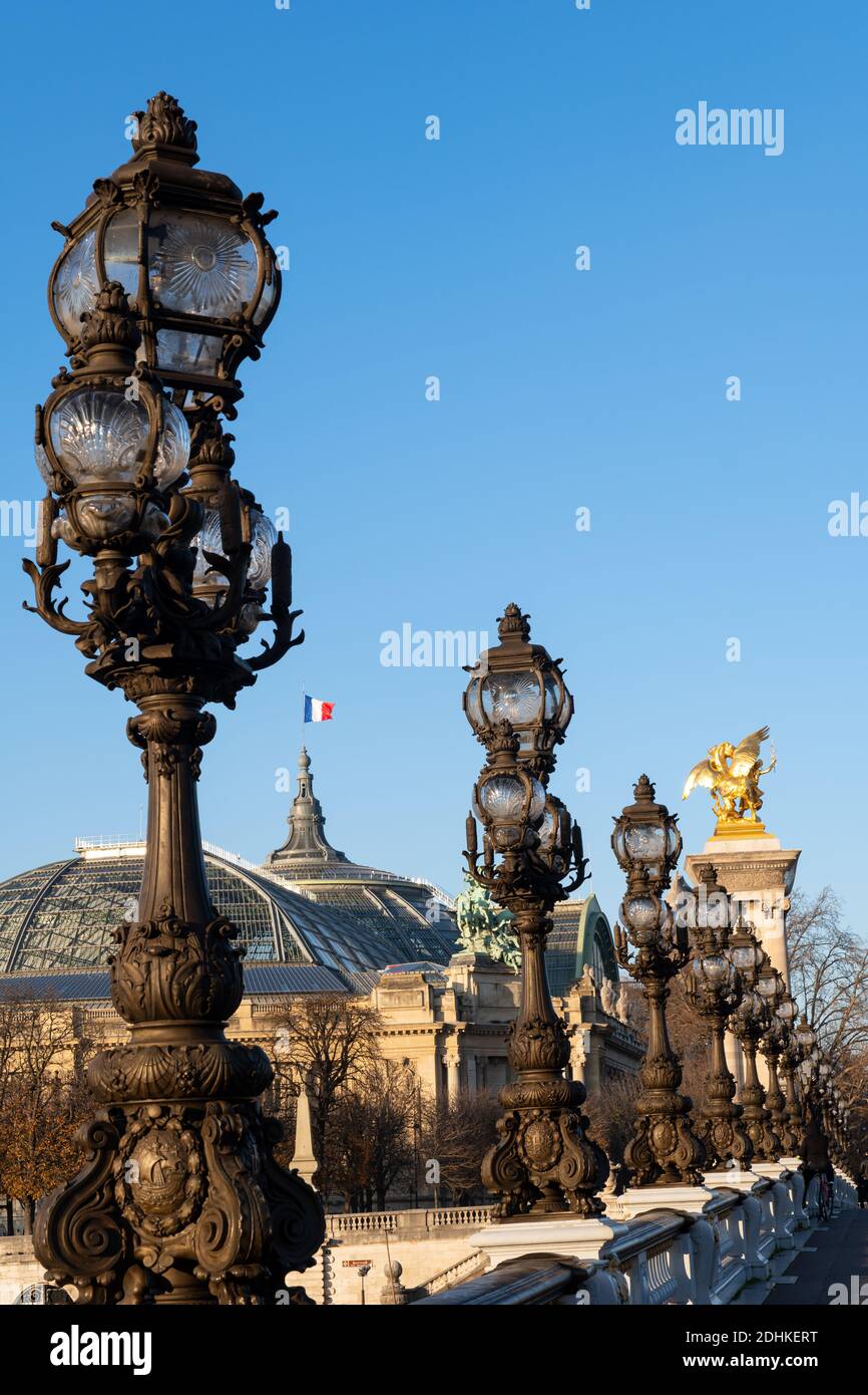 Street lamp on Pont Alexandre III with Grand Palais in the background - Paris Stock Photo