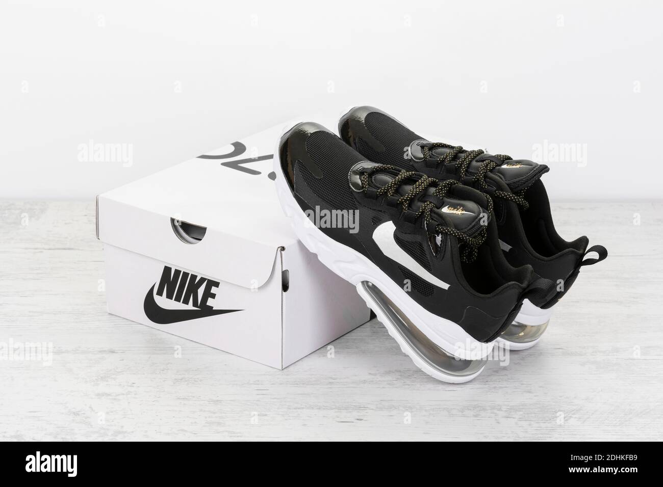 BURGAS, BULGARIA - DECEMBER 8, 2020: Nike Air MAX 270 REACT women's shoes - sneakers in black, on white wooden background. Stock Photo