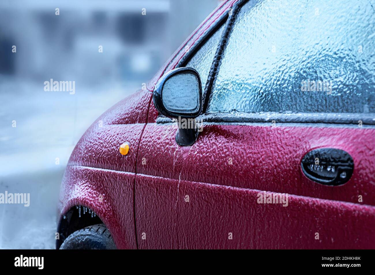 Car body and sideview mirror froze after freezing rain. Abnormal weather, freezing rain covered