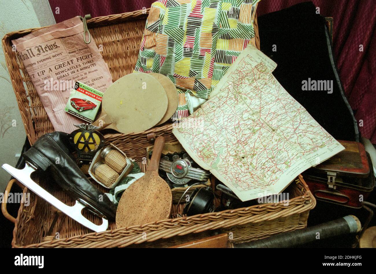 Old wicker basket containing memorabilia from the past, UK Stock Photo