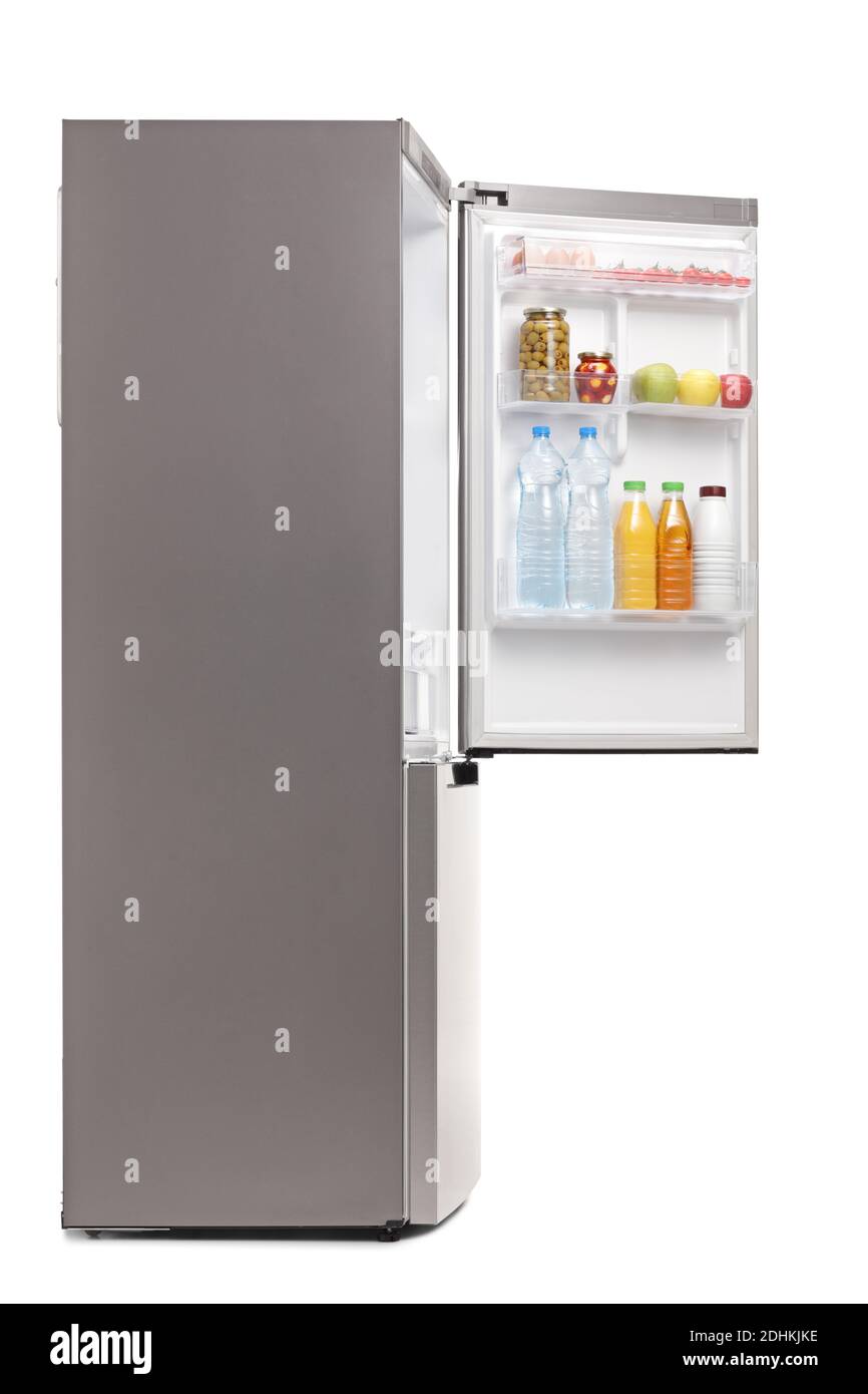 Side shot of a fridge with an open door with food and drinks isolated on white background Stock Photo