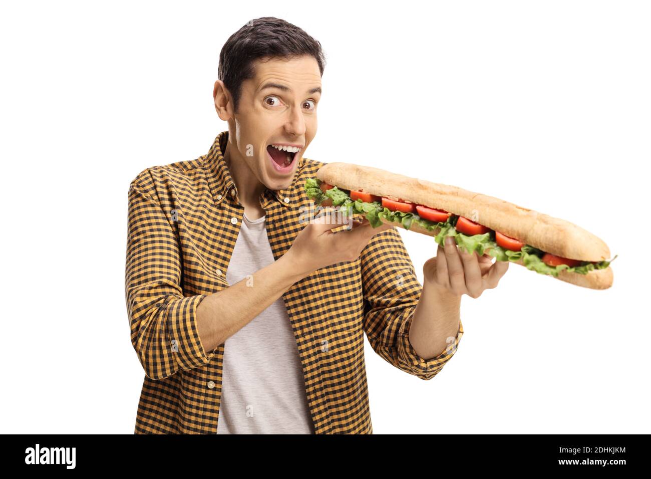 Happy excited young man eating a long sandwich in a baguette loaf isolated on white background Stock Photo
