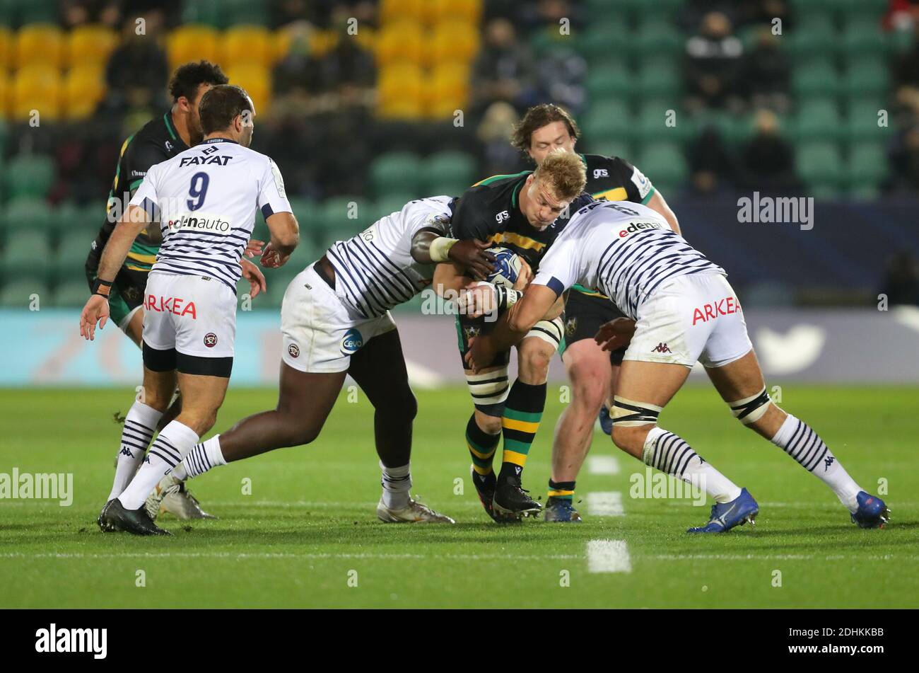 Northampton Saints' David Ribbans (centre) is tackled by Bordeaux-Begles' Thierry Paiva and Cyril Cazeaux (right) during the European Champions Cup Group A match at Franklin's Gardens, Northampton. Stock Photo
