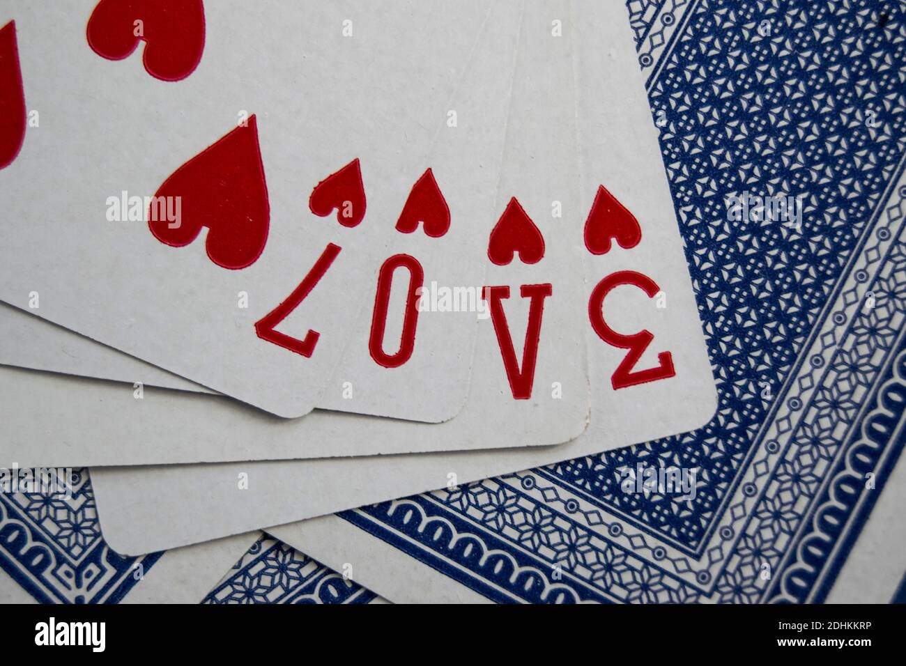 A hand of playing cards that spells love Stock Photo