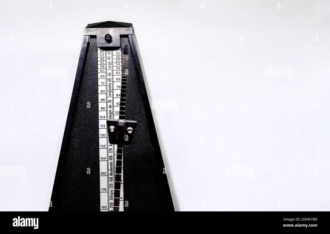 Detail of the pendulum of a classic metronome. Rhythm measurement tool. Mechanical movement without electricity Stock Photo