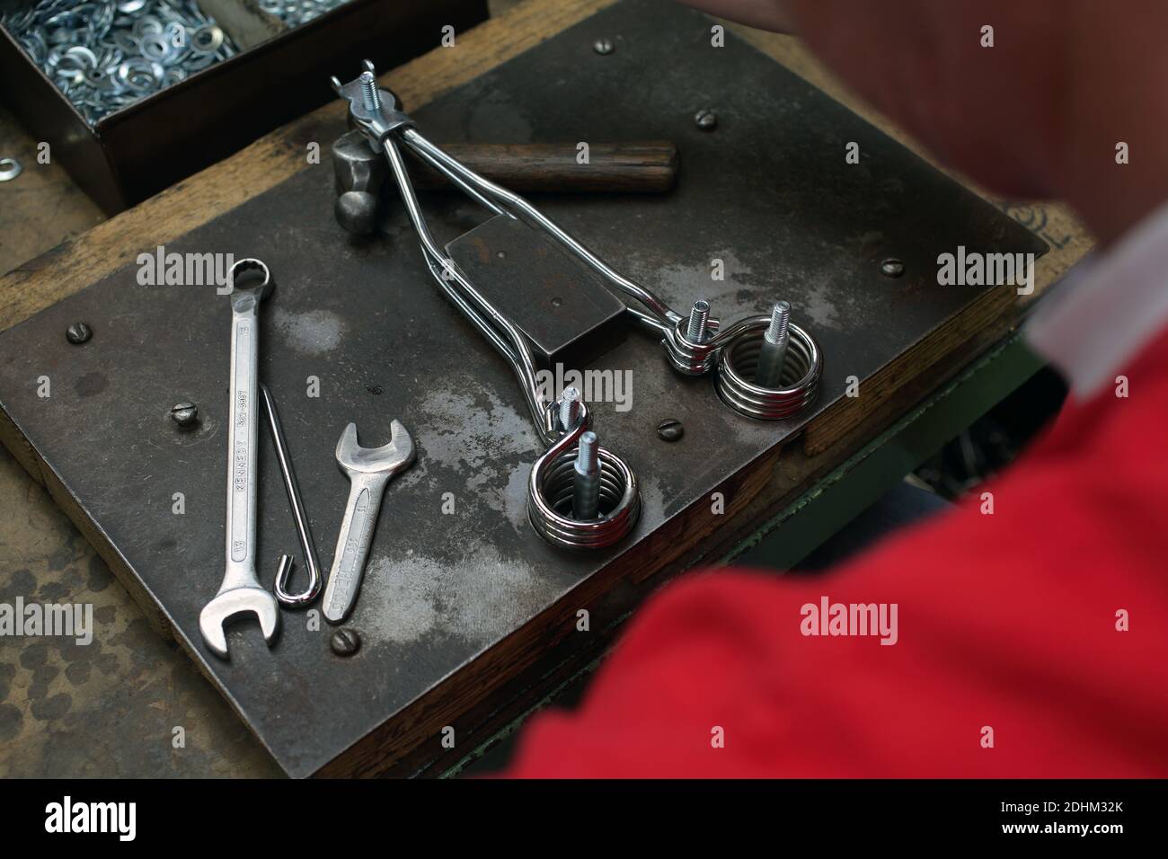 Machining the metal parts for Brooks bicycle seats. Brooks saddle factory in Birmingham, UK. Stock Photo