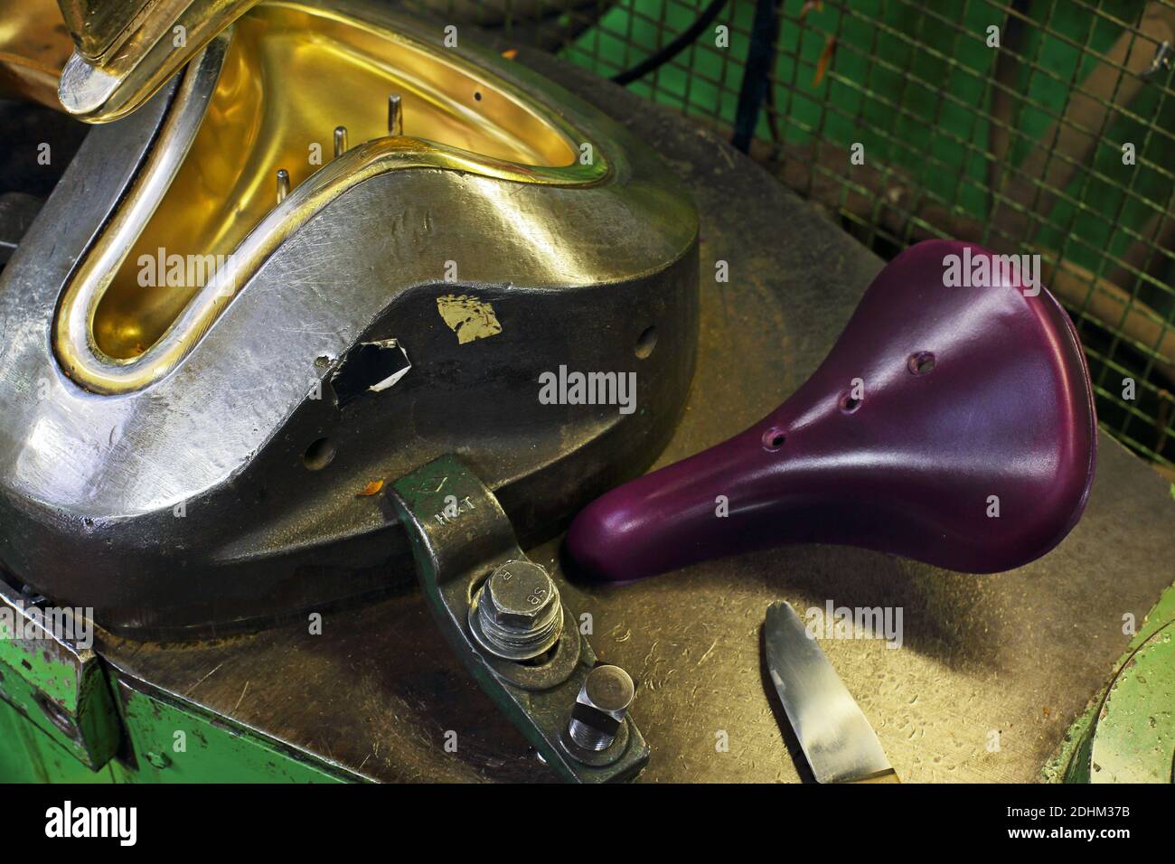 Stamping out a Brooks bicycle seat. Brooks saddle factory in Birmingham, UK.Brooks England is a bicycle saddle manufacturer founded at 1866. Stock Photo