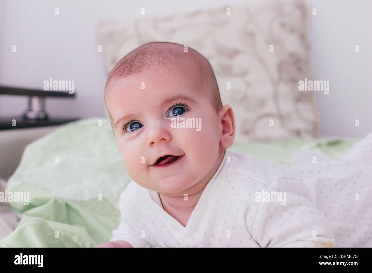 adorable baby boy with big eyes and long eyelashes. cute baby lying on