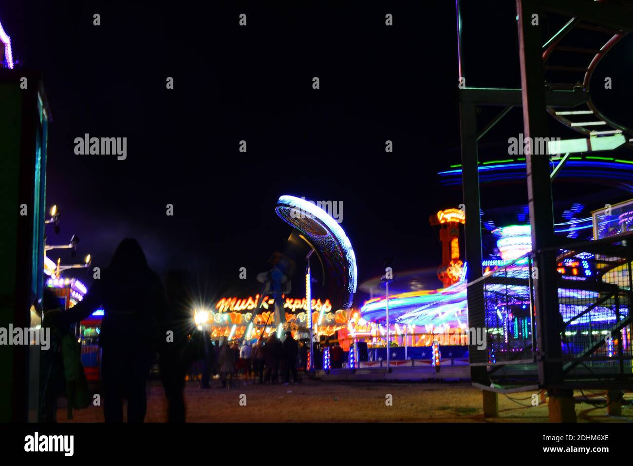 Park with rides at night Stock Photo