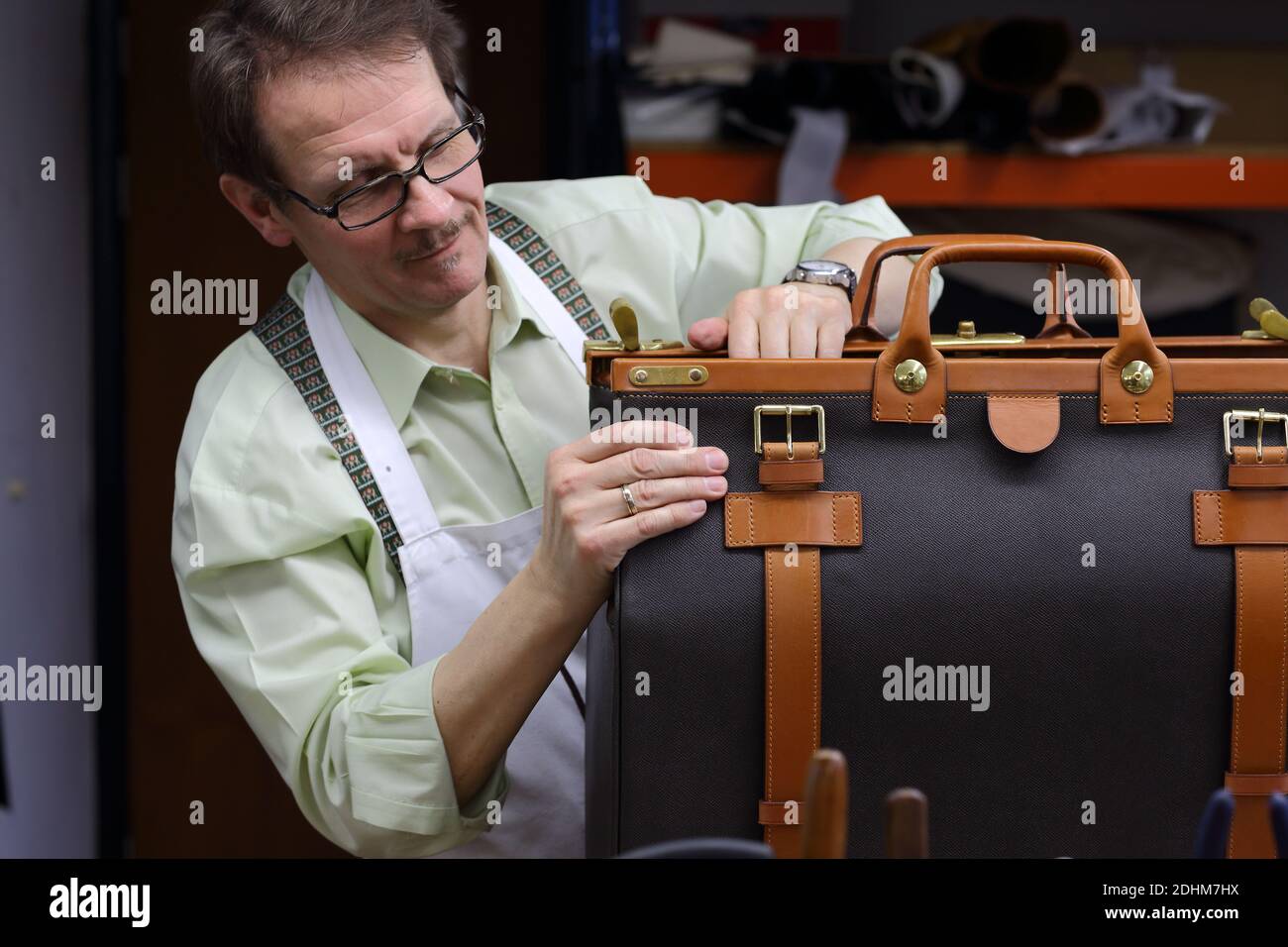 Craftsman making bespoke leather bag Stock Photo