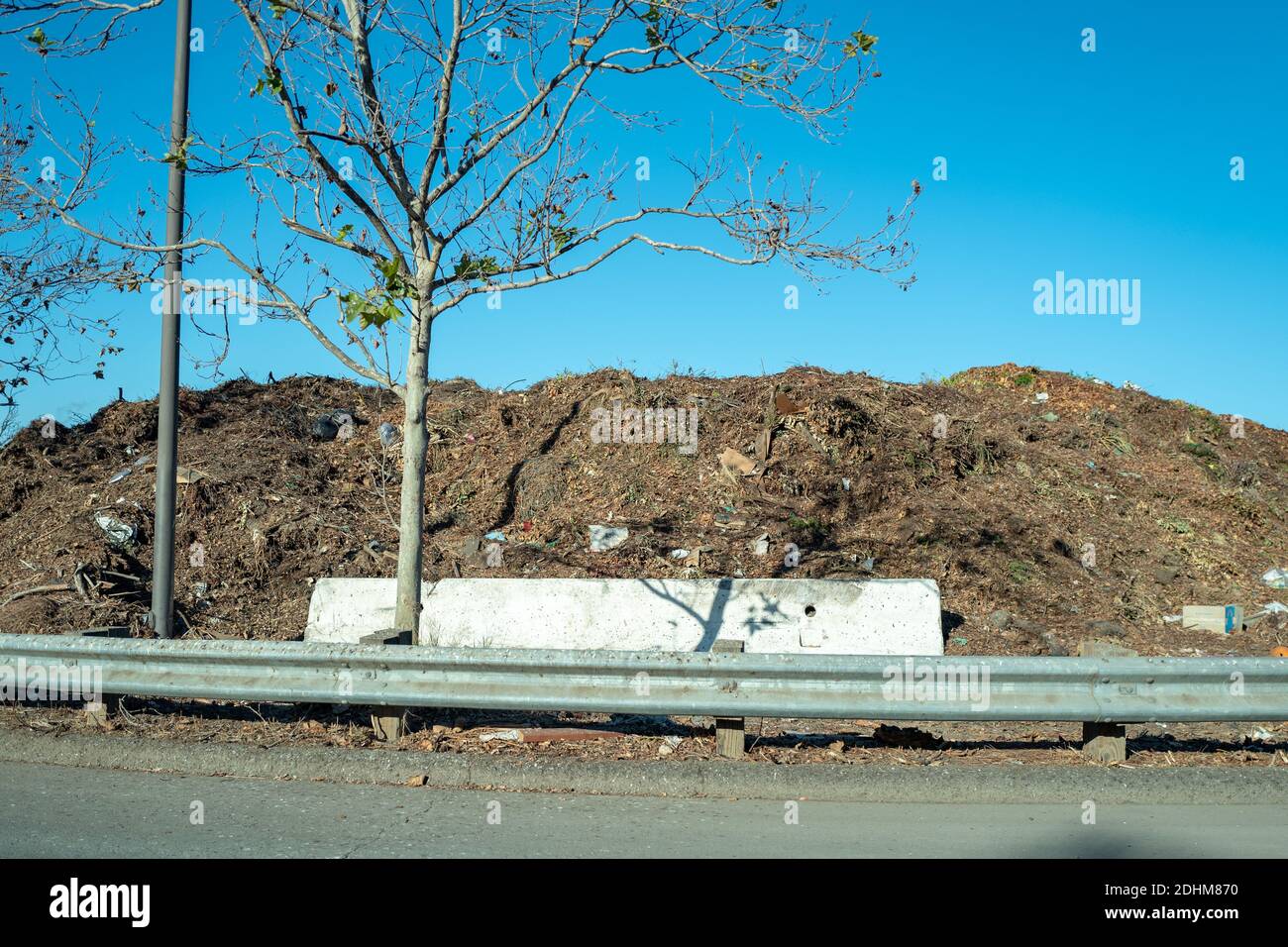 Large pile of organic waste is visible behind a barricade at organic waste dumping area of the Martinez Transfer Station municipal solid waste dump in Martinez, California, December, 2020. () Stock Photo