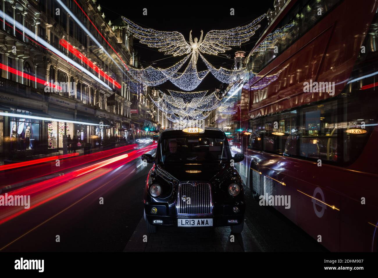 Golden angel christmas decorations and light trails on Regent Street. Stock Photo