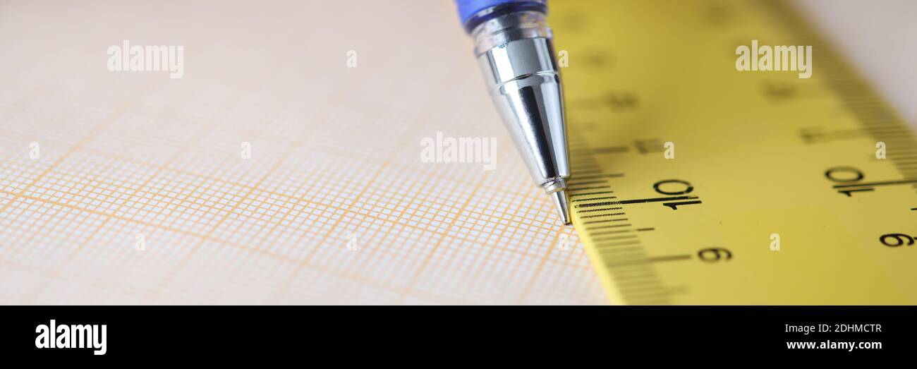 On table is graph paper with pen draw line along ruler Stock Photo - Alamy