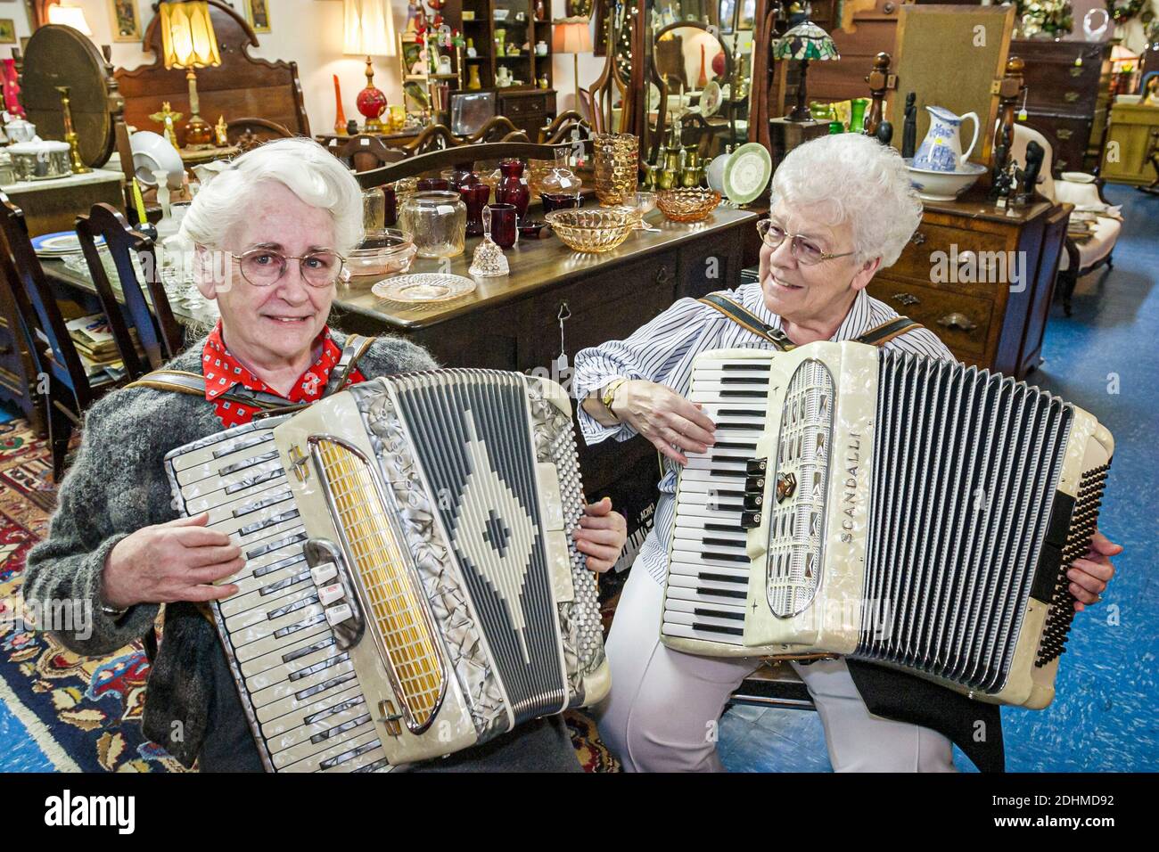 Alabama Hartselle Main Street Old Town Hall Antiques,senior seniors women woman female friends play playing accordion accordions,antique shop store in Stock Photo