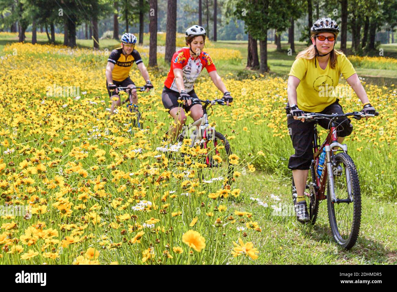 Birmingham Alabama,Oak Mountain State Park,mountain bike trail man woman female women riding bicycles wildflowers flowers, Stock Photo