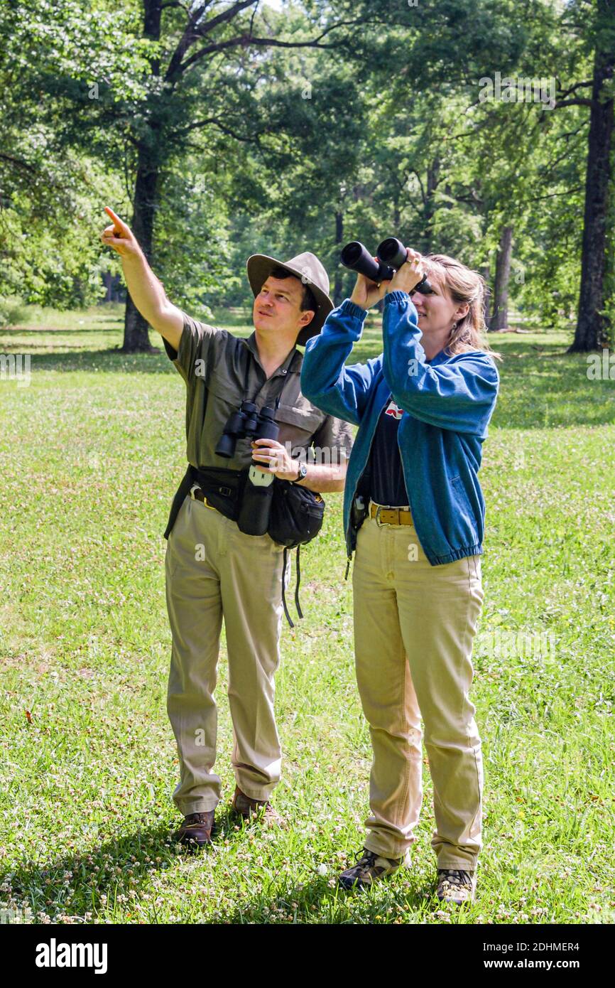 Alabama Decatur Hospitality Nature Park birding birder,man binoculars woman female couple looking points pointing, Stock Photo
