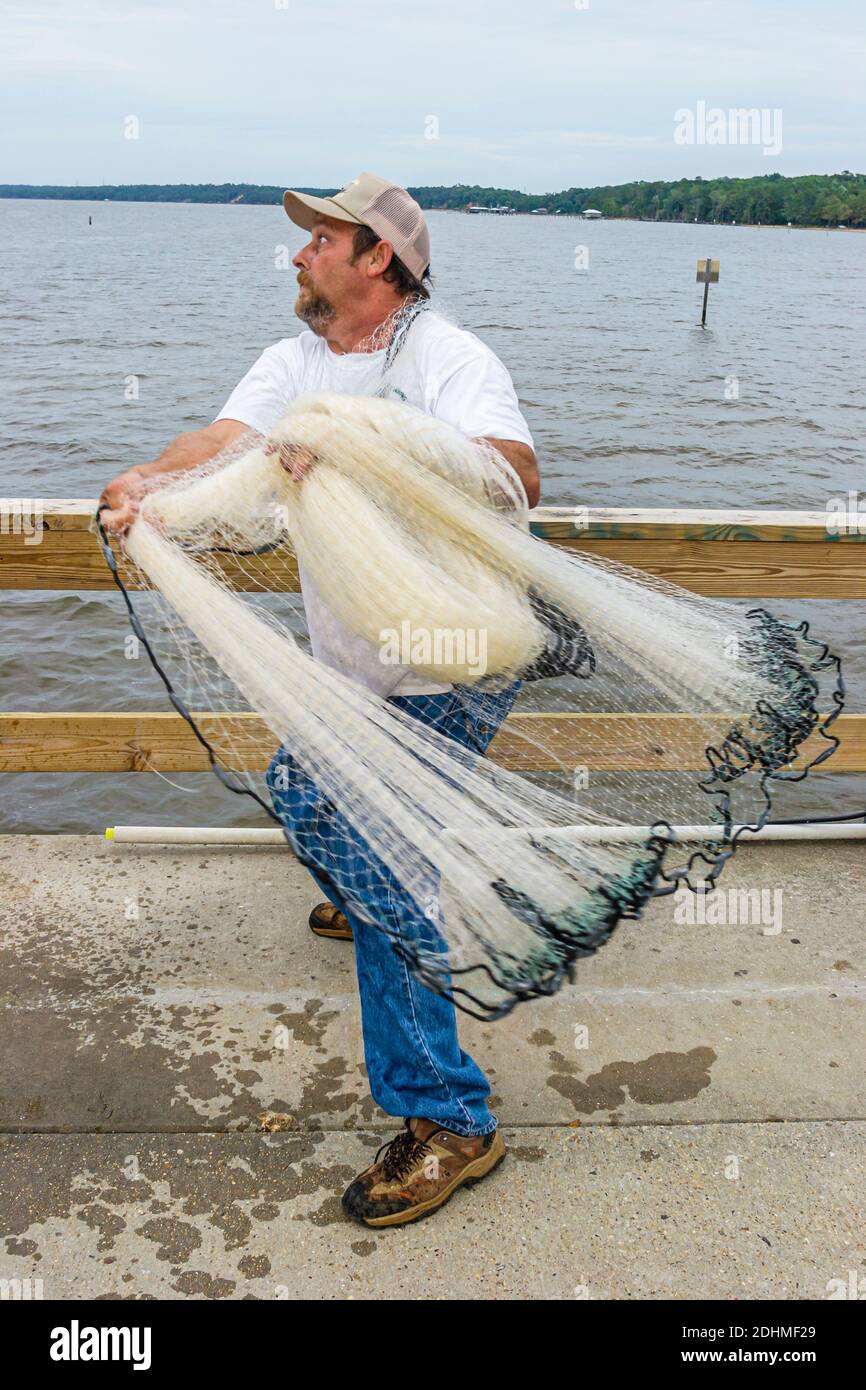 Alabama Fairhope Municipal Park Pier Mobile Bay,man casting net, Stock Photo