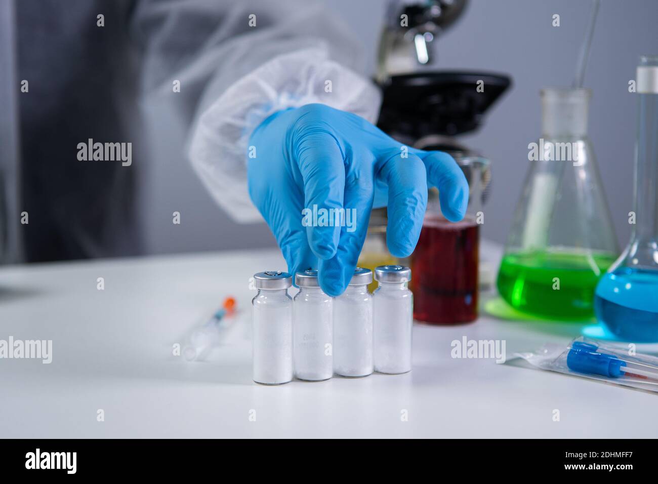 Development and search for drug for coronavirus. Chemist examining ampoule  of powdered antibiotic for injection. Treating bacterial infection with med  Stock Photo - Alamy
