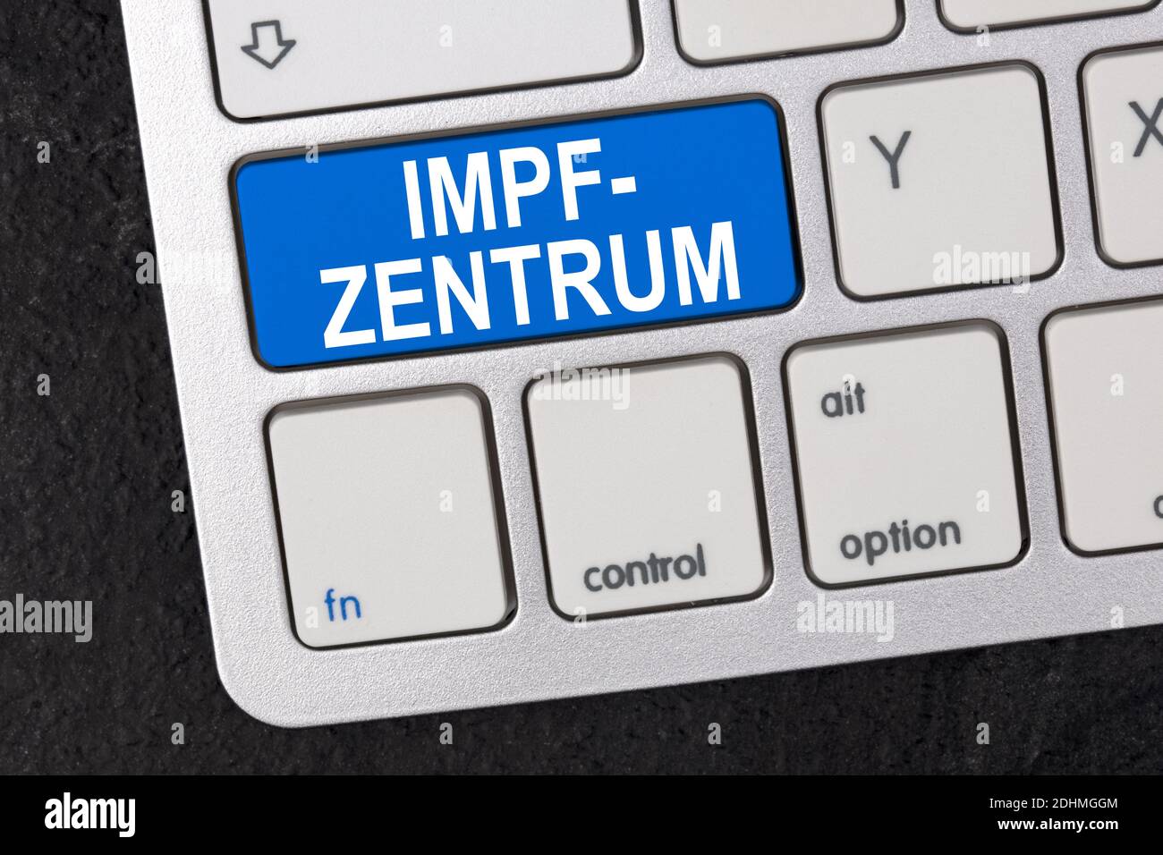 Concept: Impfzentrum in german language means - Vaccination center on a Keyboard on dark background Stock Photo